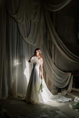 Bride standing in light posing at wedding at Elvetham hotel