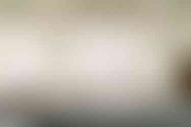 Bride and groom walking holding hands across balcony at Islington town hall wedding