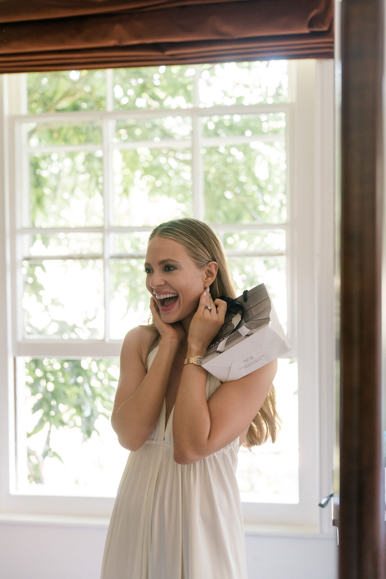 Avington wedding  with bride looking very happy holding her face