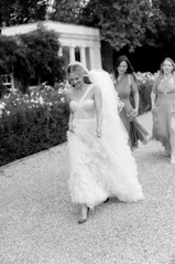 Bride walking with bridesmaids at Avington wedding 