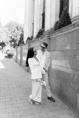 Bride and groom looking at each other wearing sunglasses after Islington town hall wedding