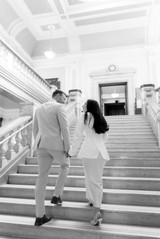 Bride and groom walking up stairs at Islington town hall wedding