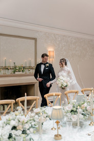 Bride and groom walking round table to Foxhill Manor Wedding photographer