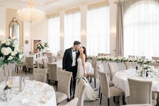 Wedding at Rushton hall with bride and groom standing in the middle of white and green table set up