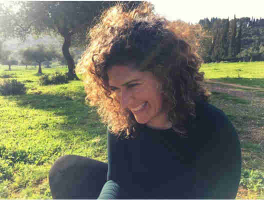 Raizel Druxman sitting outside on the grass