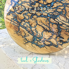 Fractal Burned Round Charcuterie Board filled with Teal and Black in our Shadows style