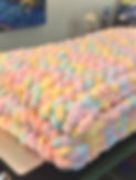 Pastel Rainbow Hand Woven Kid's Blanket folded on a desk.JPG