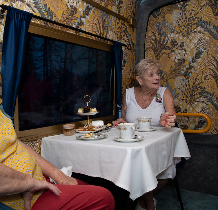 guest seated at table watching the view from the virtual window
