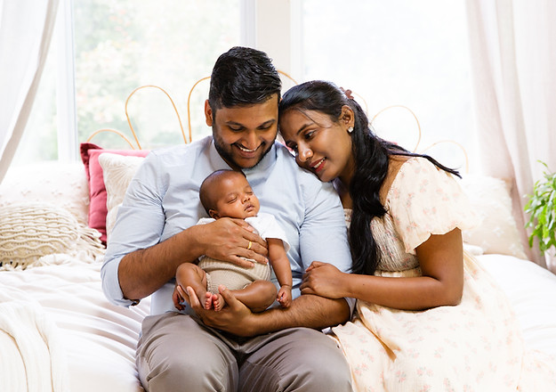 Newborn in studio session with parents holding baby boy