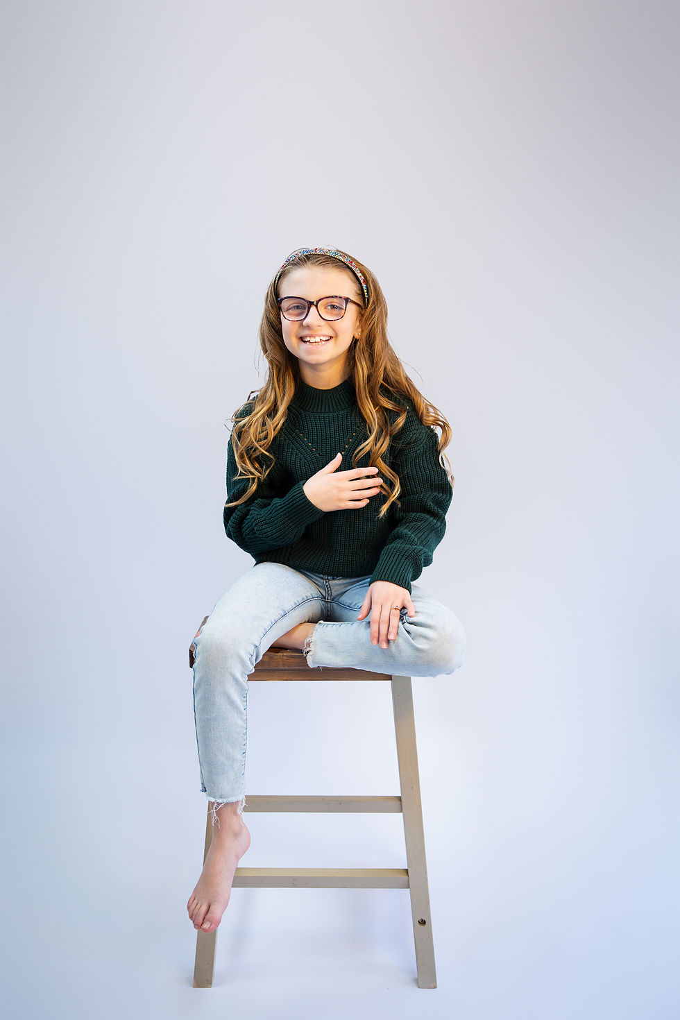 girl sitting on stool posing for fine art portraits