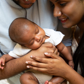 Mom and dad holding newborn baby boy