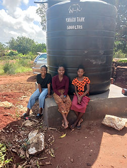 Girls waiting for water from the tank