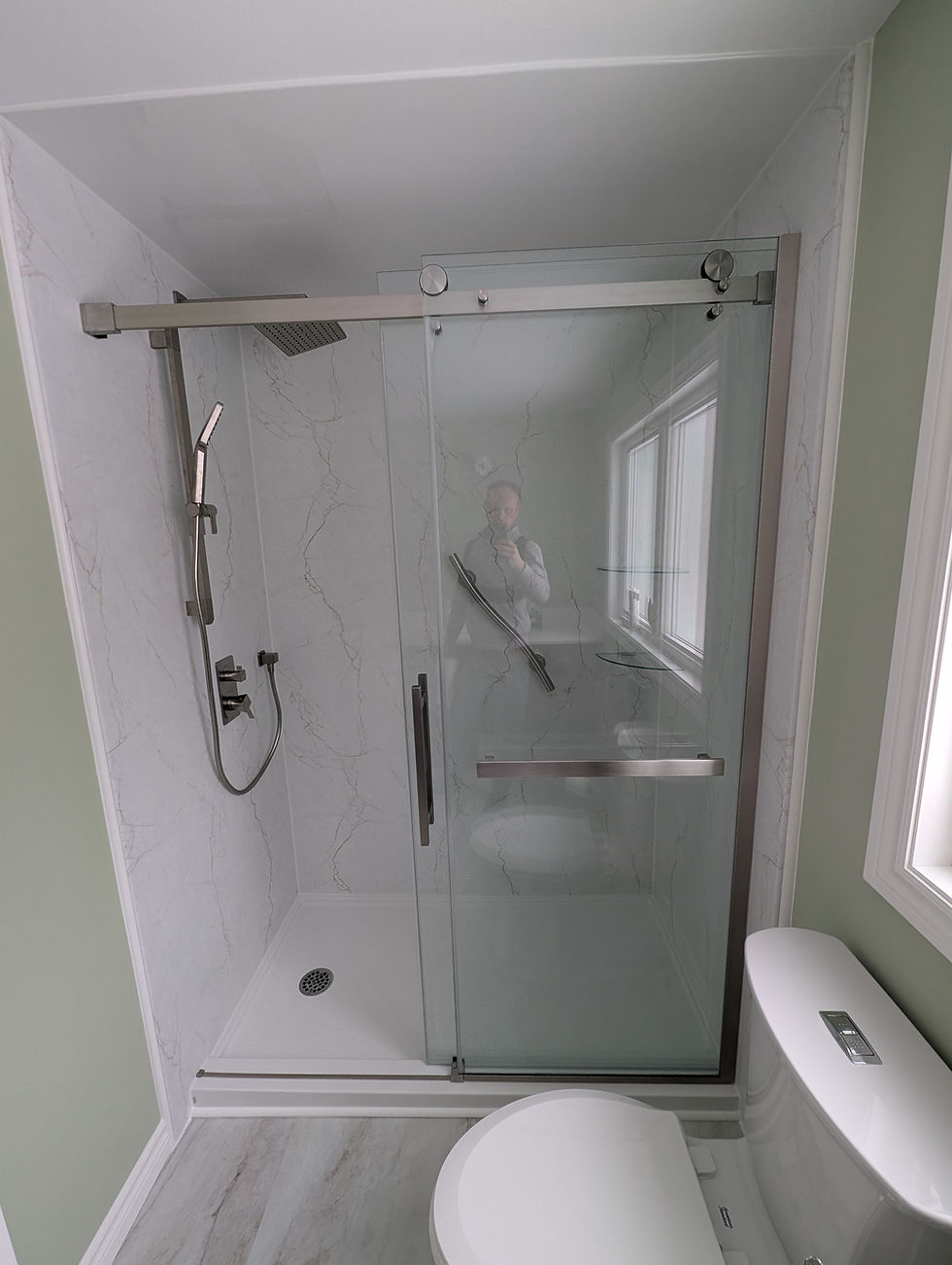 Quality bathroom renovations featuring a glass shower door.