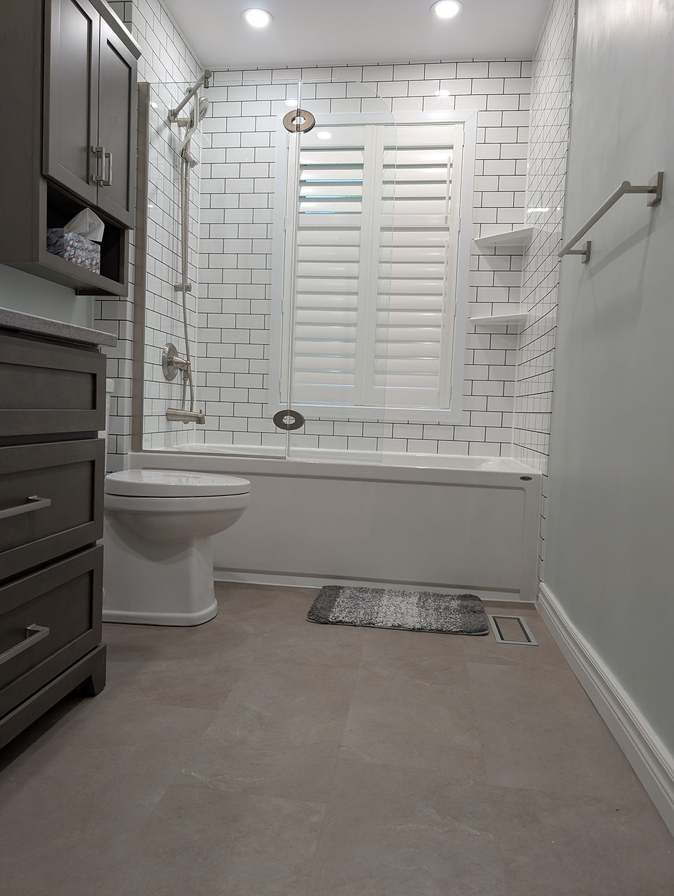 Quality bathroom renovations featuring a white tiled tub.