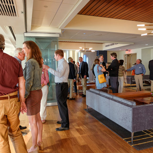 Guests mingle and enjoy lively conversation in the inviting atmosphere of Pilot View Center, highlighting the venue’s warm, social setting perfect for networking, celebrations, or casual gatherings.
