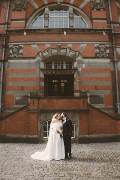 Georgia and Will beneath the red-brick façade of The Pumping House