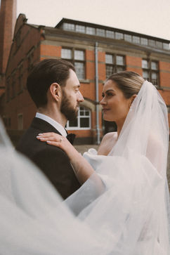 Georgia and Will framed by The Pumping House red-brick exterior