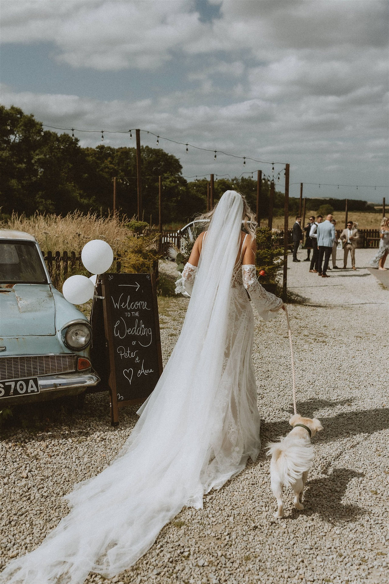 Bride walking her dog on her wedding day