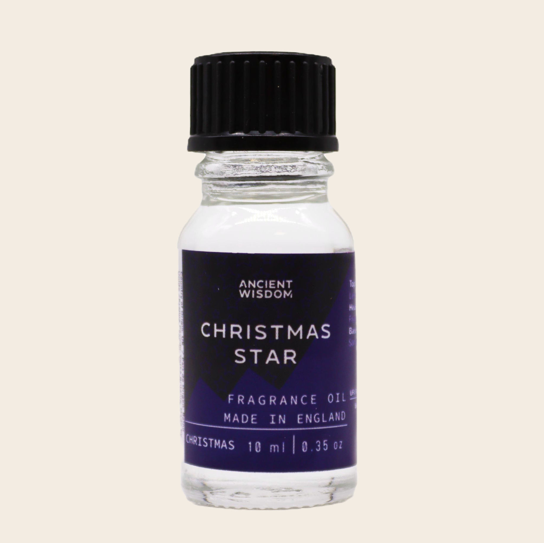 Ancient Wisdom Christmas Star Fragrance Oil 10ml bottle on a beige background