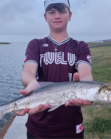 Ways we connect future fishers: young boy holding a fish.