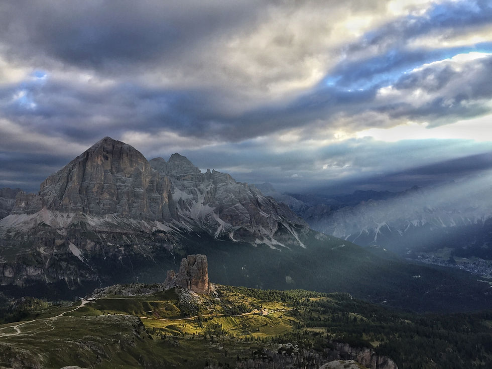 Sunlight over the 5 Torri with the Tofane peaks in the background, a dramatic Dolomites landscape near Cortina d’Ampezzo.