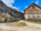 Rifugio Palmieri (Croda da Lago) beside Lago Federa in the Dolomites, surrounded by rocky cliffs and alpine forest near Cortina d’Ampezzo.