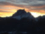 Sunset over Mount Pelmo and the Dolomites above San Vito di Cadore, with snow‑covered peaks and pink clouds glowing in the evening sky.