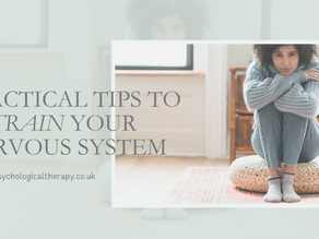 Woman in blue sweater sits on a pouf, hugging her knees in a bright room. Text: "Practical tips to retrain your nervous system.”