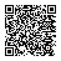 Close-up view of raffle tickets beside a QR code sign on a wooden table.