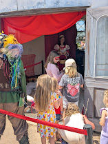 Kids standing in line to be knighted by Queen Strawberry.