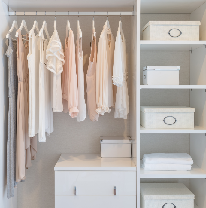 Beautifully organized neutral-tone closet with storage boxes and shelving, Coastal Home Solutions by Natasha, professional home organizer in Leland, NC.
