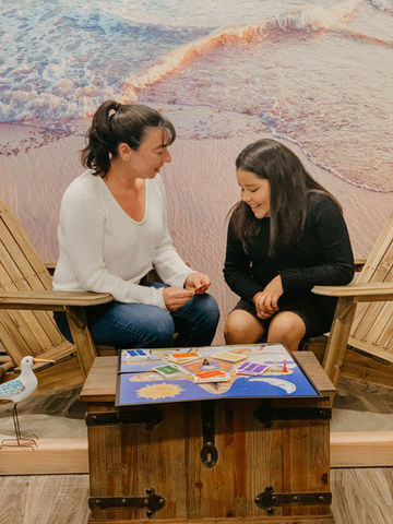 Adult and younger woman playing a board game