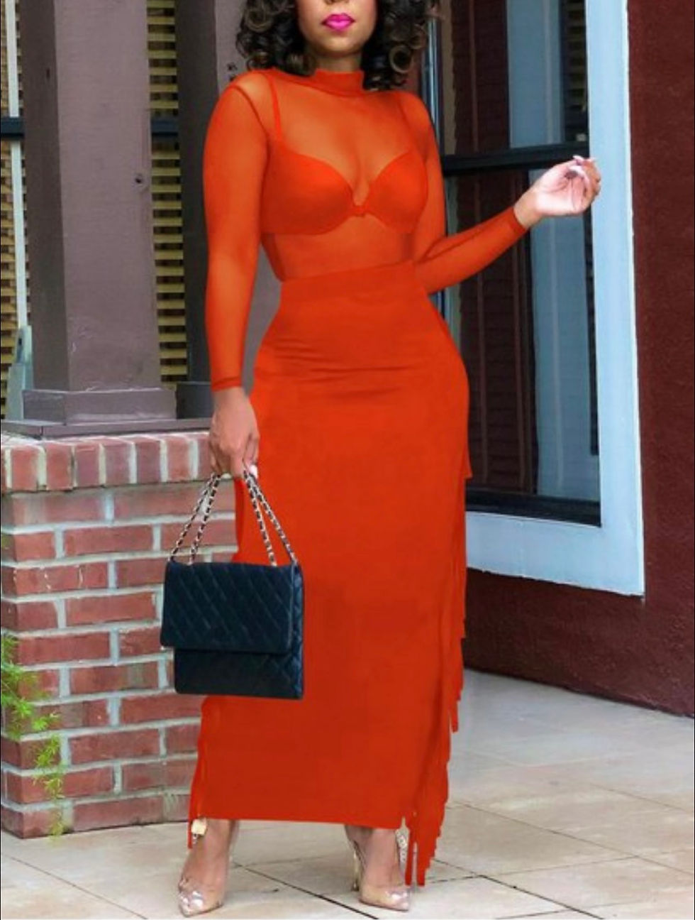 Thumbnail: Woman in red dress holding handbag in front of brick wall and door Madame Curves