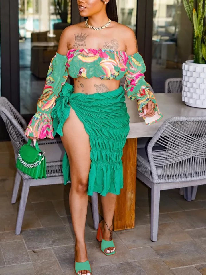 Thumbnail: Woman in a green outfit with a matching bag and a table outside Madame Curves