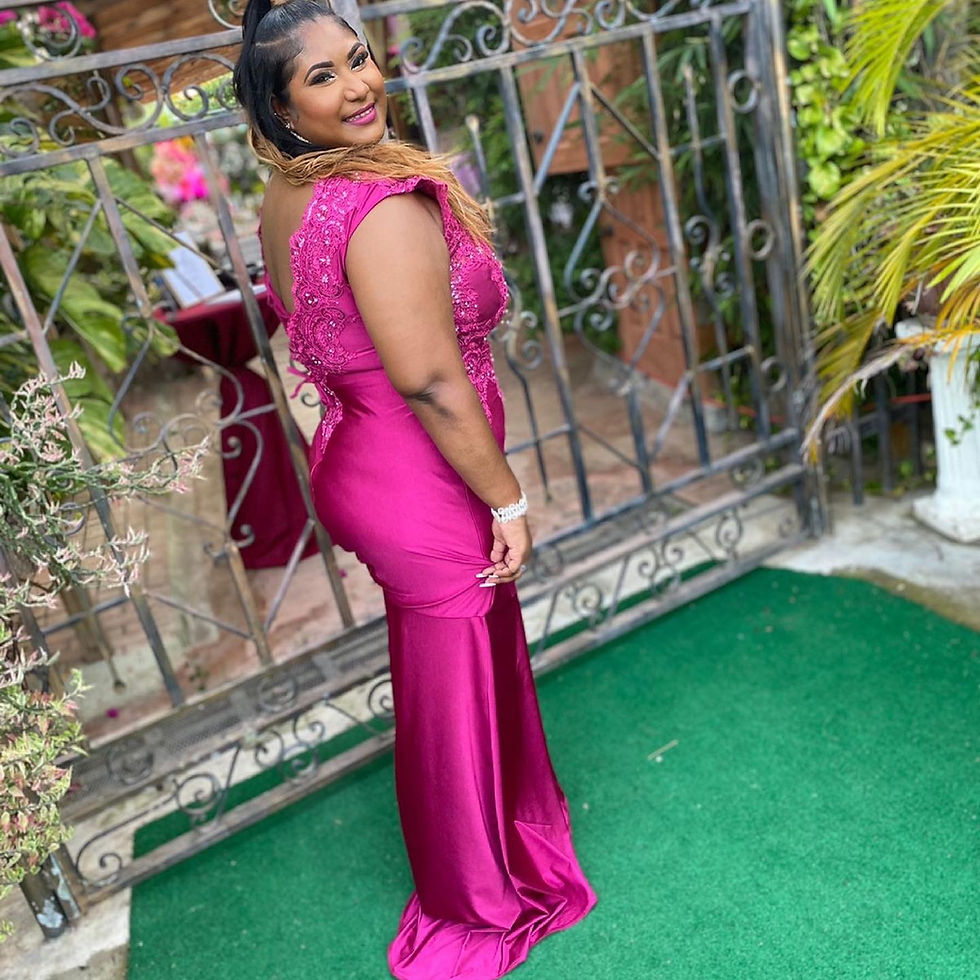 Thumbnail: Woman in a pink dress smiles, posing outdoors near a gate Madame Curves