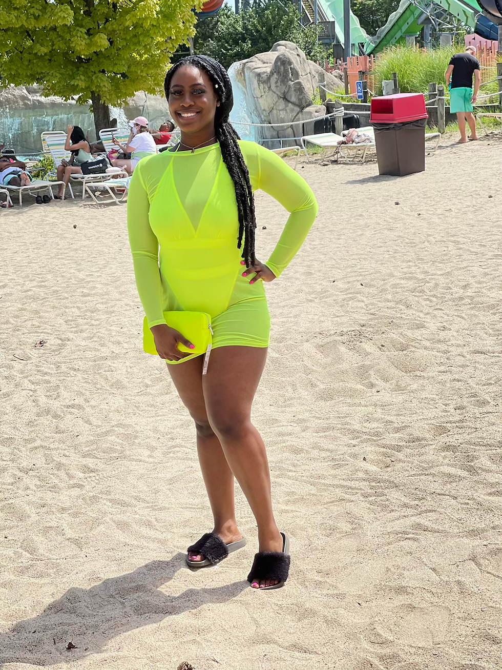 Thumbnail: Woman in neon outfit poses on the beach, holding a clutch. Madame Curves