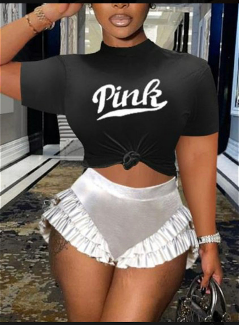 Thumbnail: Woman wearing a black top with "Pink" text and a white shorts set.