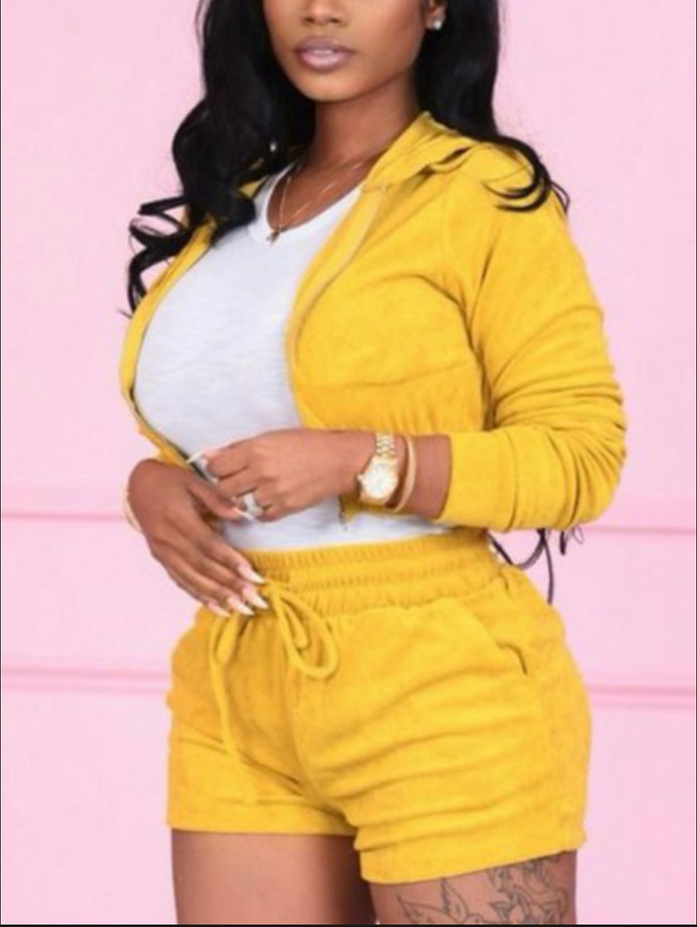 Thumbnail: Woman in yellow tracksuit. White V-neck shirt. Fashion and style portrait.
