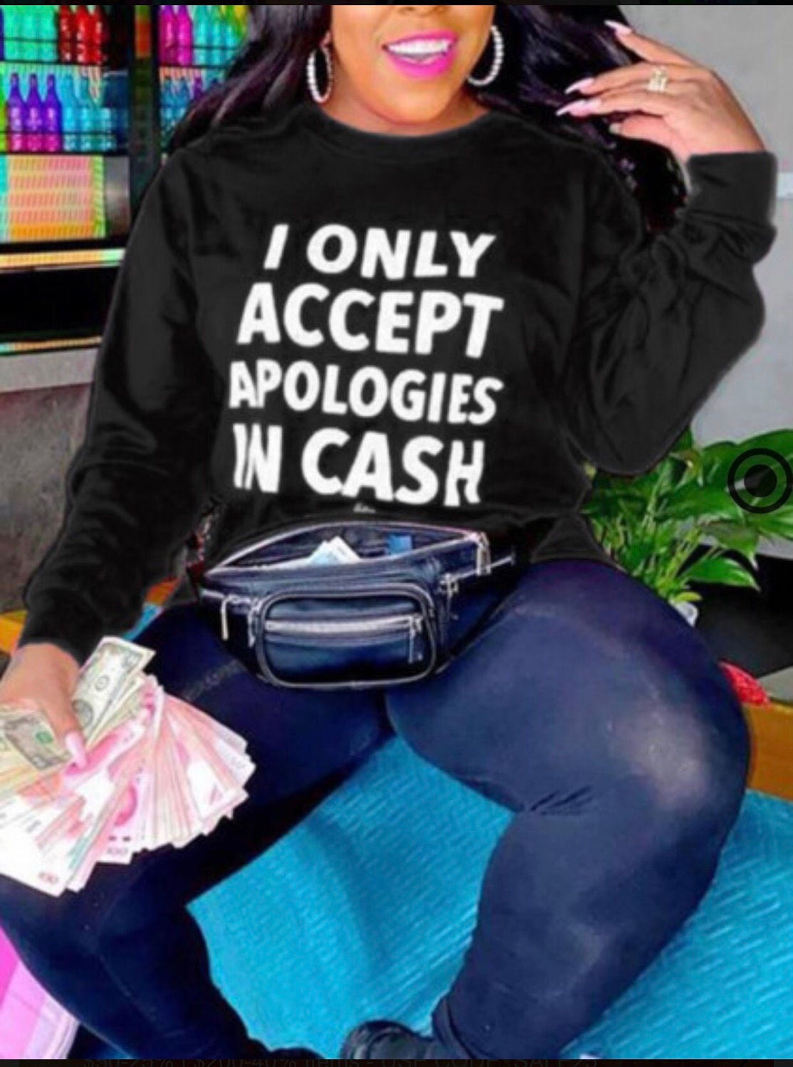 Person wearing a black shirt that says, I only accept apologies in cash.