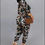 Thumbnail: Woman in leopard print outfit with a brown purse on gray background.
