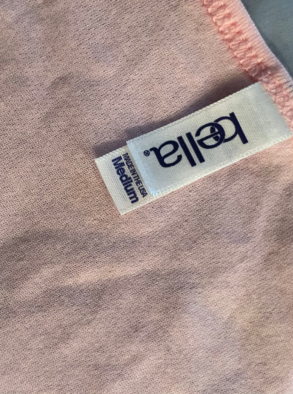 Thumbnail: Pink textile with labels printed "bella." and "Medium" for size.
