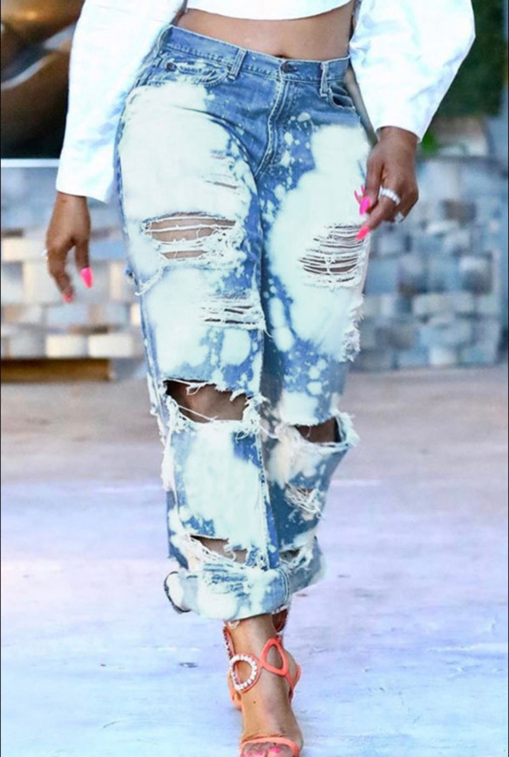 Woman wearing ripped blue jeans walking. Fashion and style concept. Madame Curves.