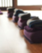 Yoga bolsters, blankets and cushions laid out for restorative workshop