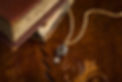 Gold gemstong and diamond necklace on leather desk