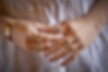 hands wearing coloured gemstone rings on each finger