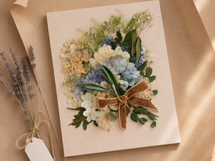Pressed hydrangea wedding bouquet with a velvet bow on kraft paper, beside dried lavender and a gift tag