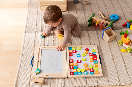 full-shot-kid-playing-with-colorful-wooden-toys.jpg