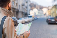 male-traveler-holding-map-hand-finding-way-city-street.jpg