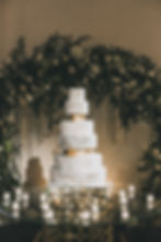 White, Gray, Gold Marbled Wedding Cake with circle flower cake backdrop and clear glass cake table.