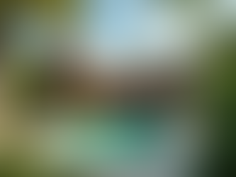 L-shaped home with a swimming pool.